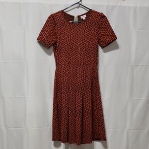 LuLaRoe Amelia dress featuring a burnt red and black aztec geometric print